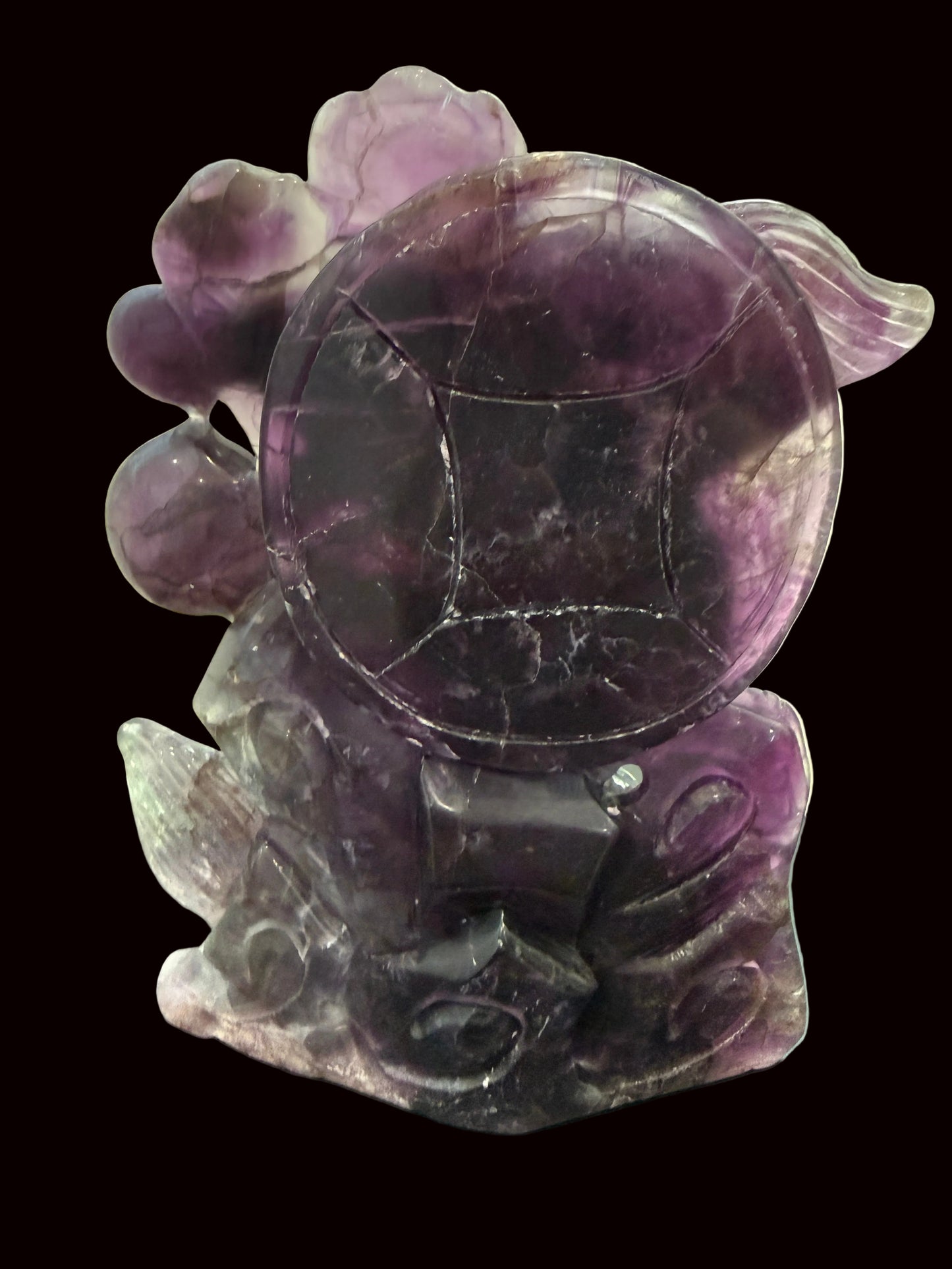 Purple fluorite dragon carving - coin detail view