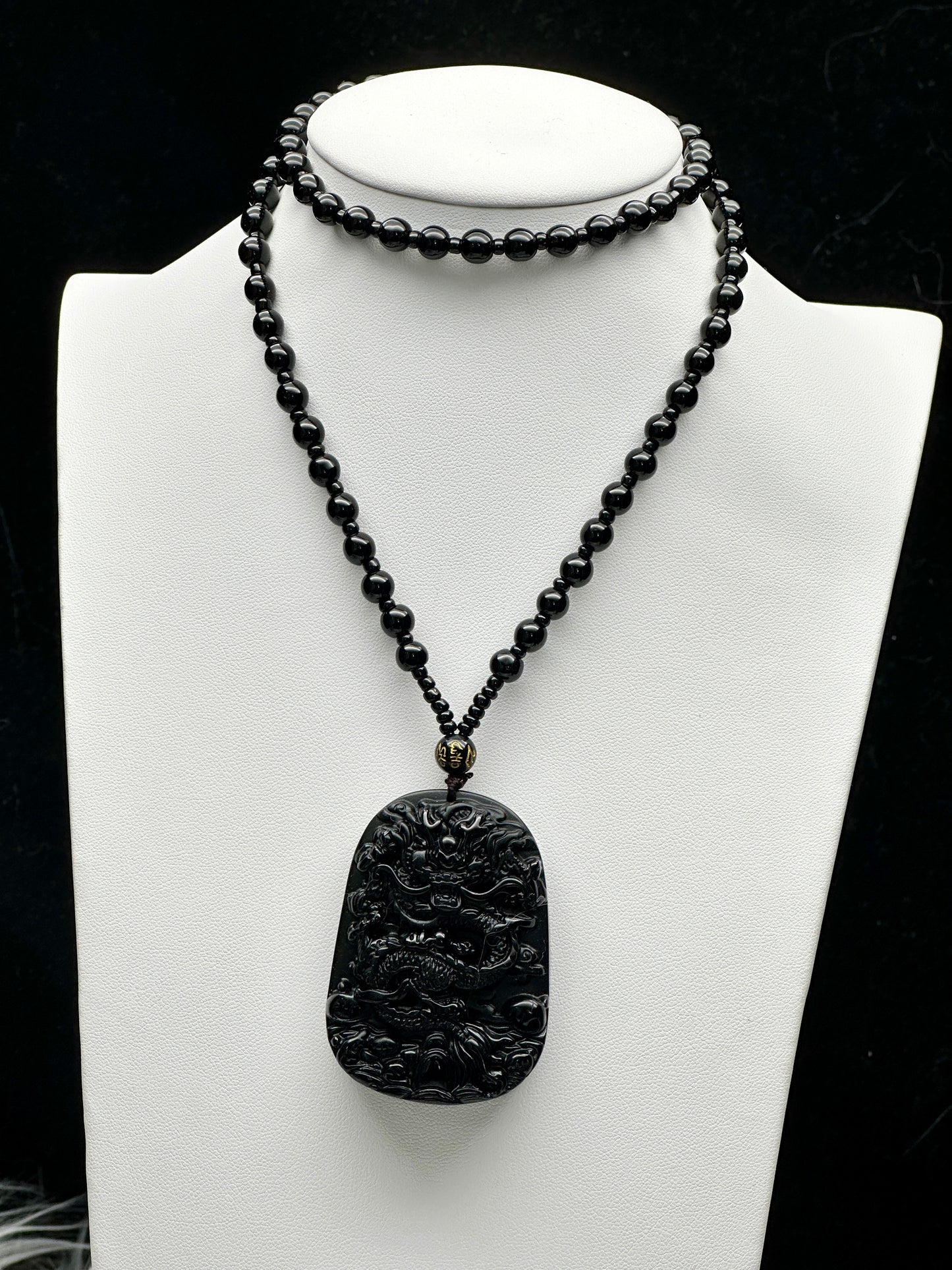 Black Obsidian Crystal Carved Dragon pendant adorning a stunning beaded necklace/Mala