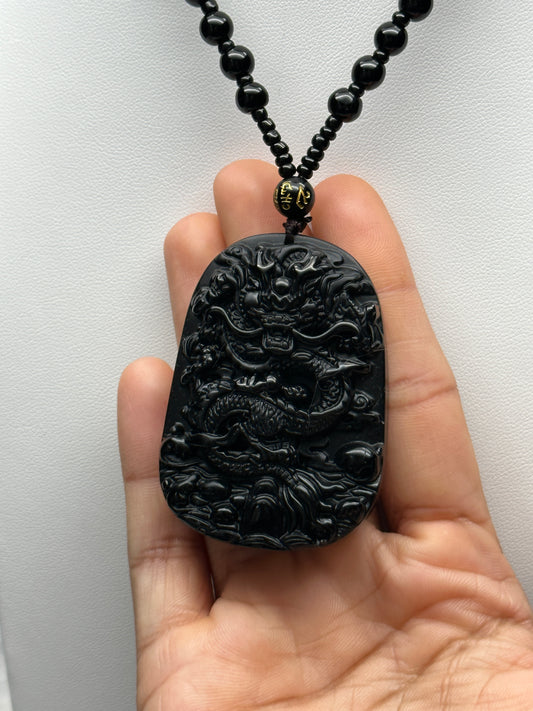 Black Obsidian Crystal Carved Dragon pendant adorning a stunning beaded necklace/Mala