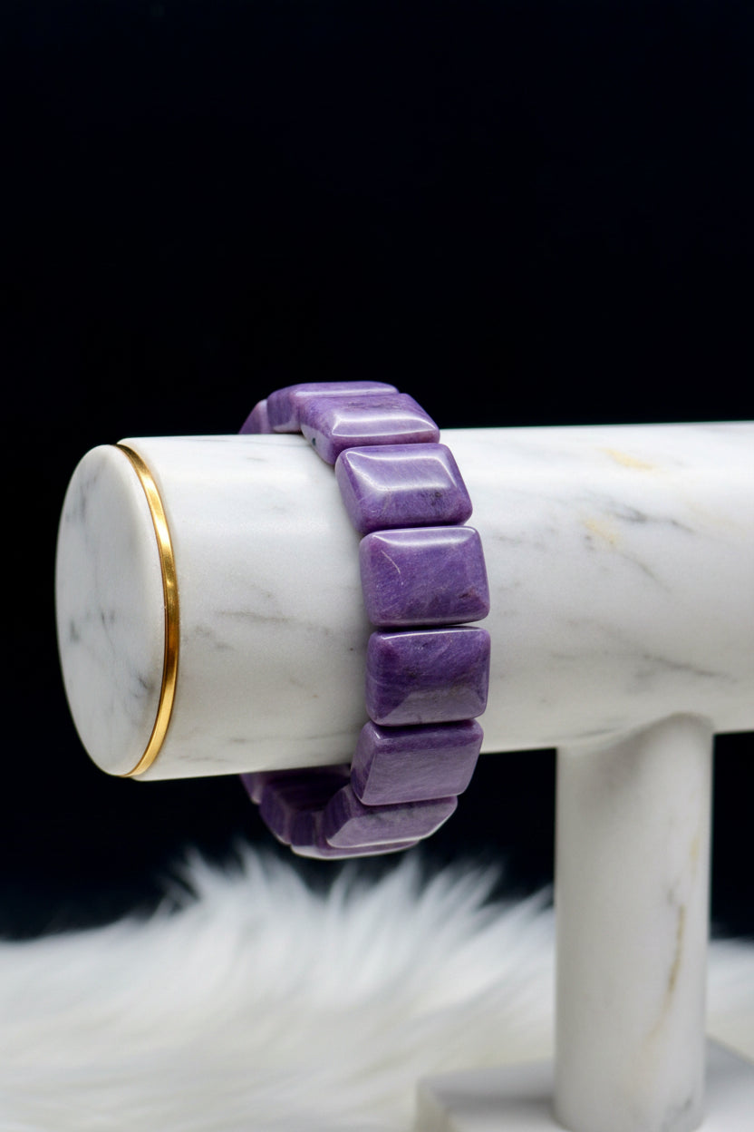 Natural charoite crystal bangle bracelet - worn on hand showing swirling purple patterns