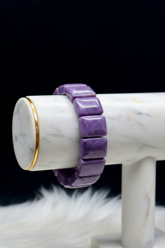 Natural charoite crystal bangle bracelet - worn on hand showing swirling purple patterns