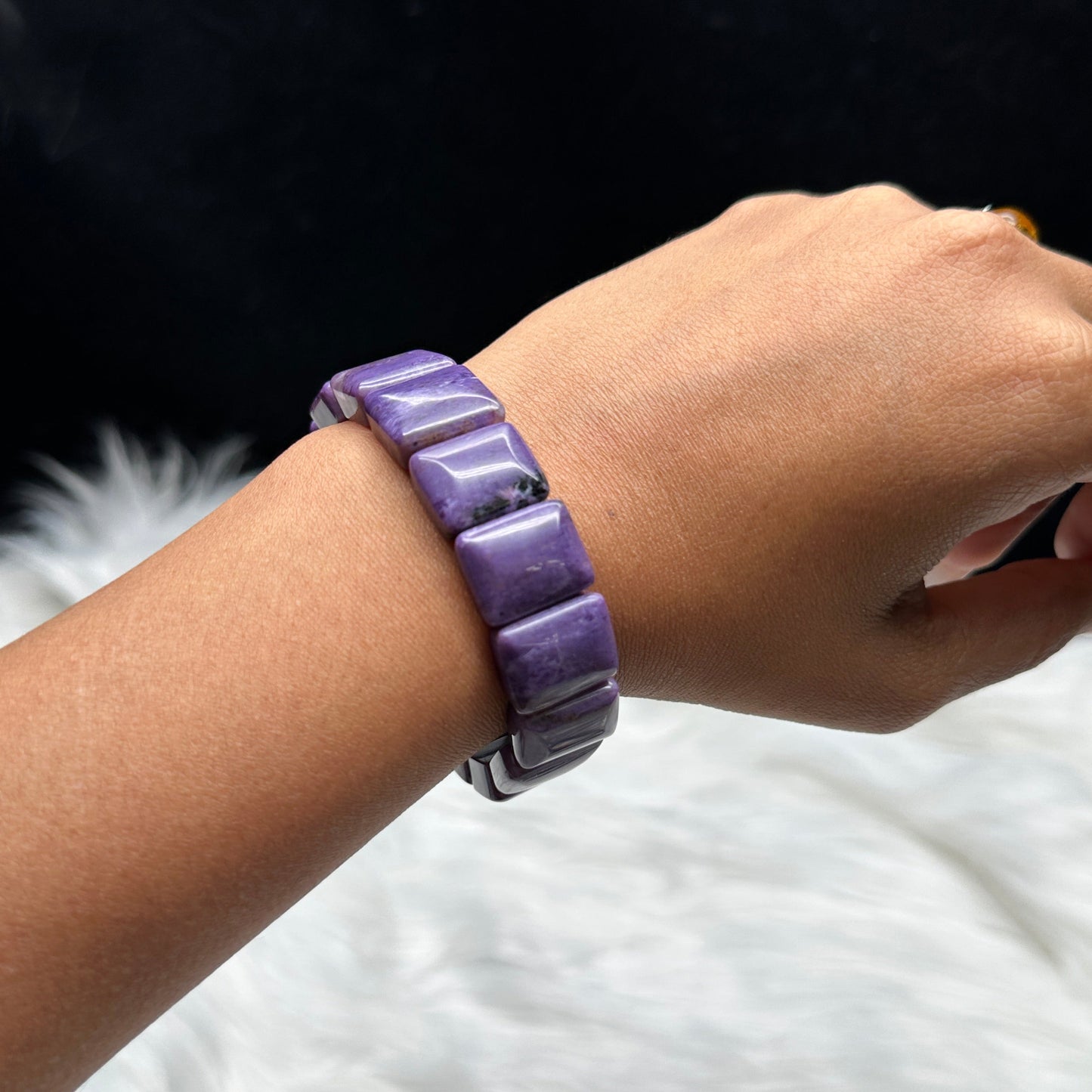 Natural charoite crystal bangle bracelet - worn on wrist with caliper showing size