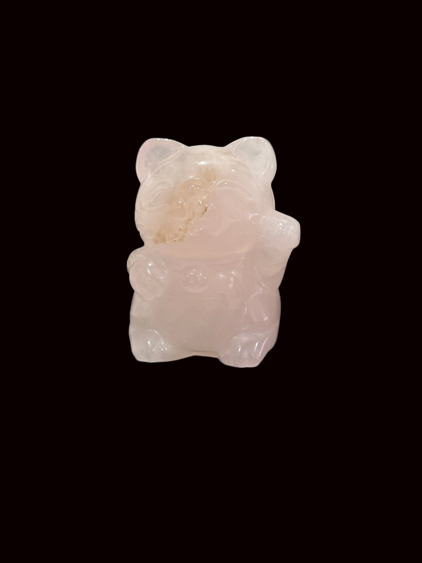 Rose quartz waving cat carving back view showing natural stone texture