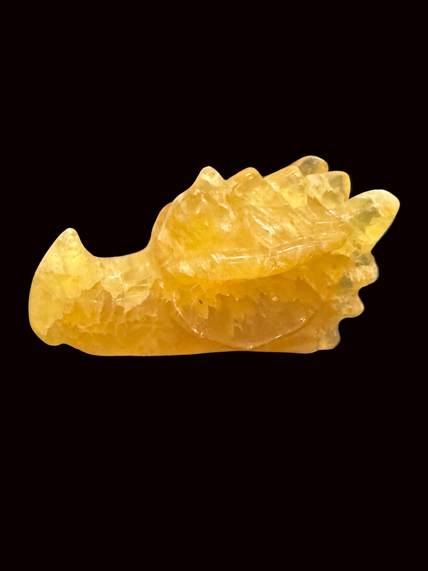 Yellow fluorite crystal dragon head carving lifestyle shot front