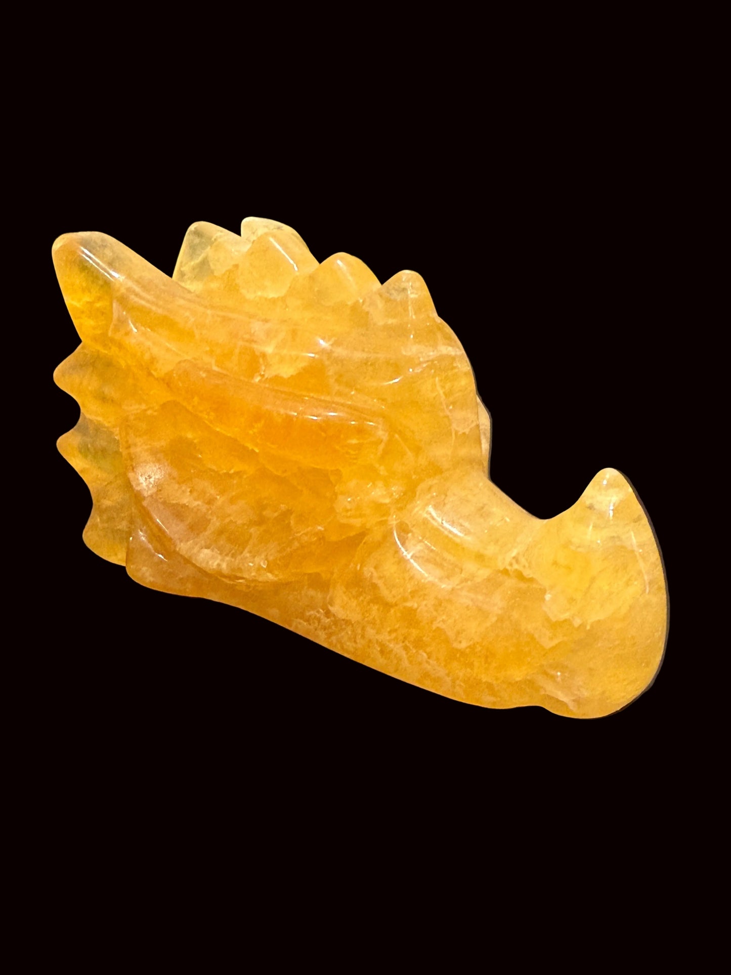 Yellow fluorite crystal dragon head carving lifestyle shot angle