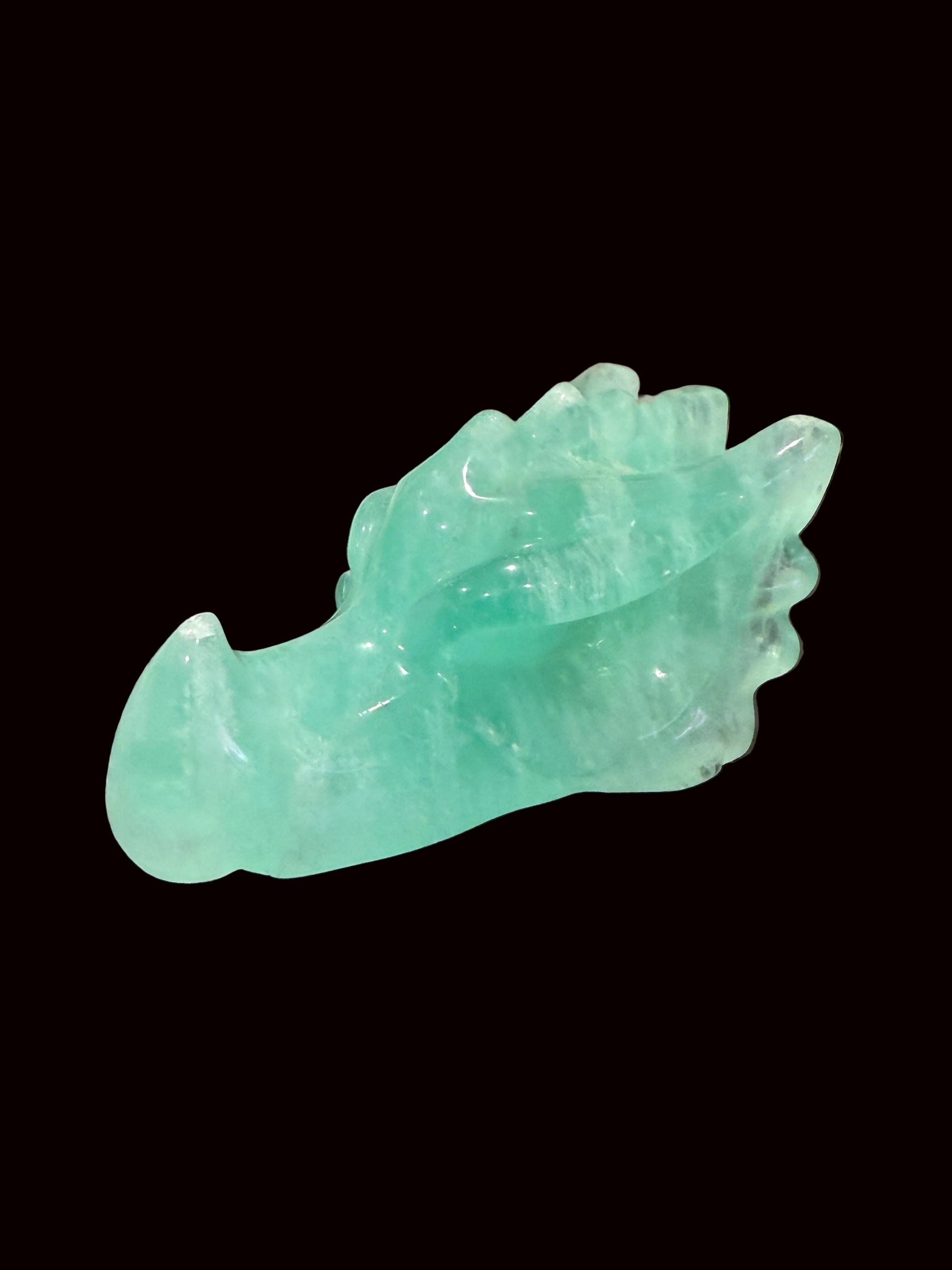 Green fluorite crystal dragon head carving three-quarter view