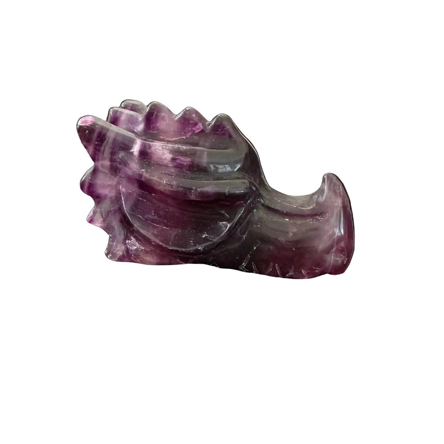 Purple fluorite crystal dragon head carving side view on dark table
