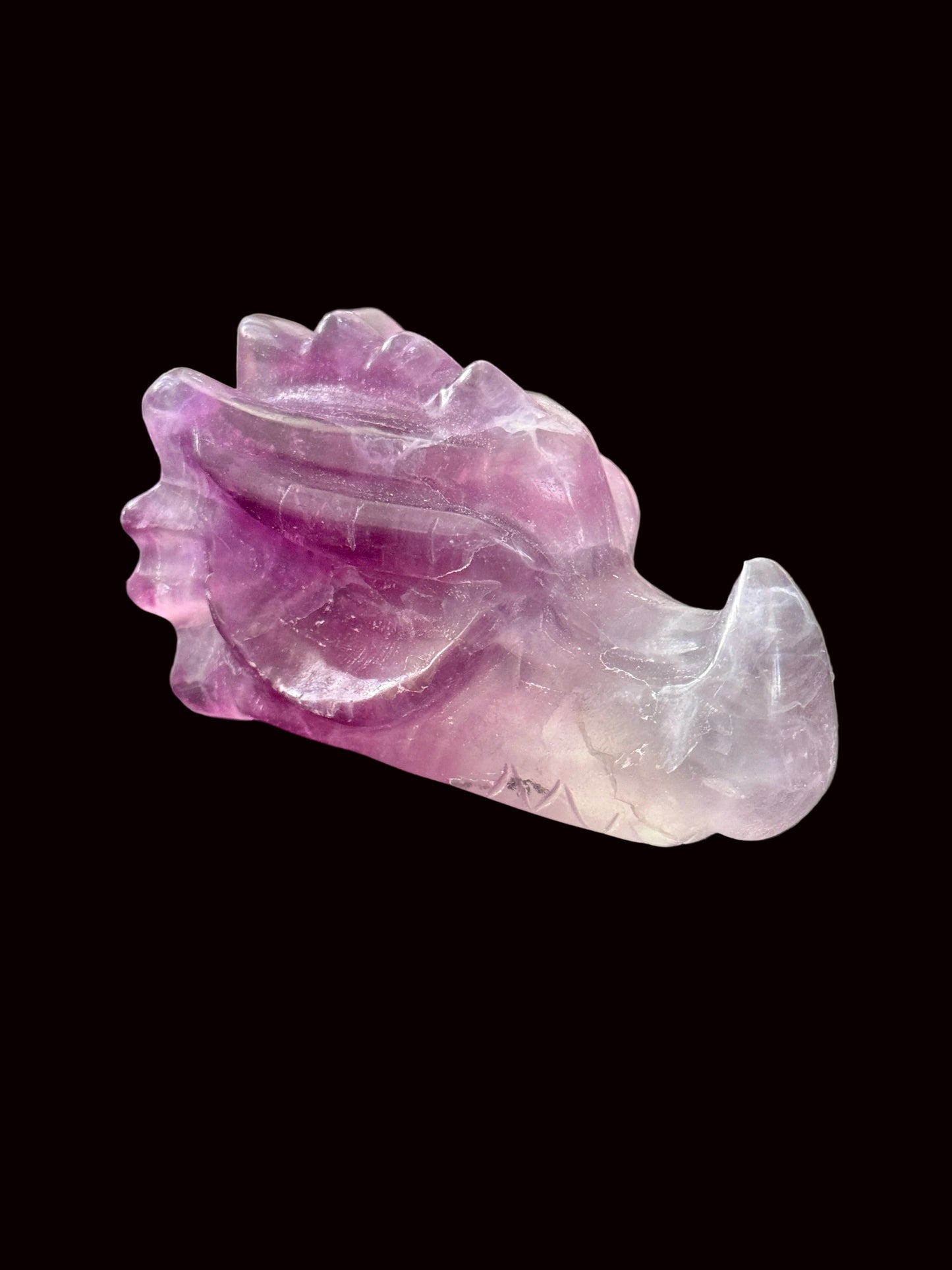 Lavender purple fluorite crystal dragon head carving back angle view showing spines