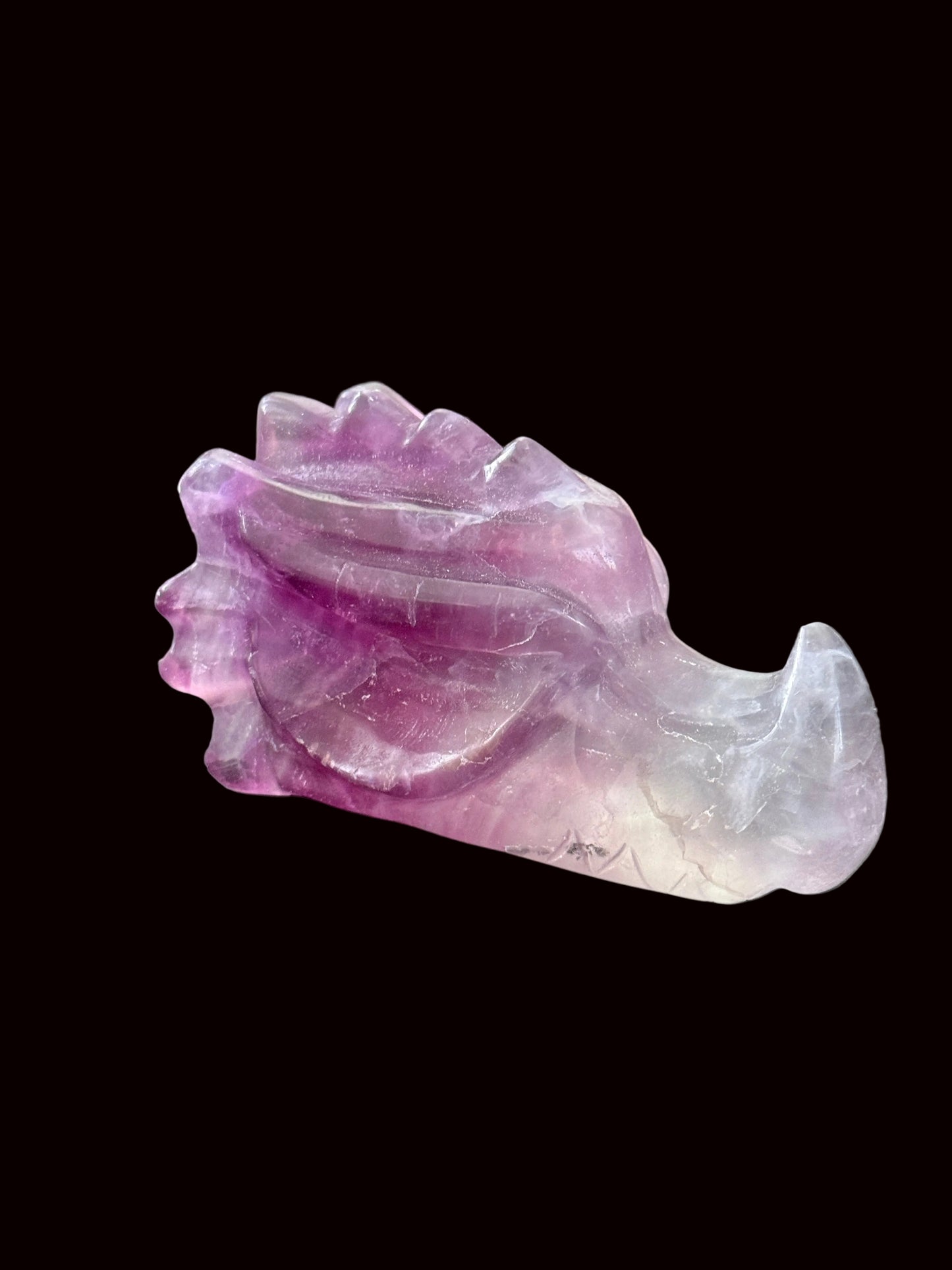 Lavender purple fluorite crystal dragon head carving top-down view showing full detail