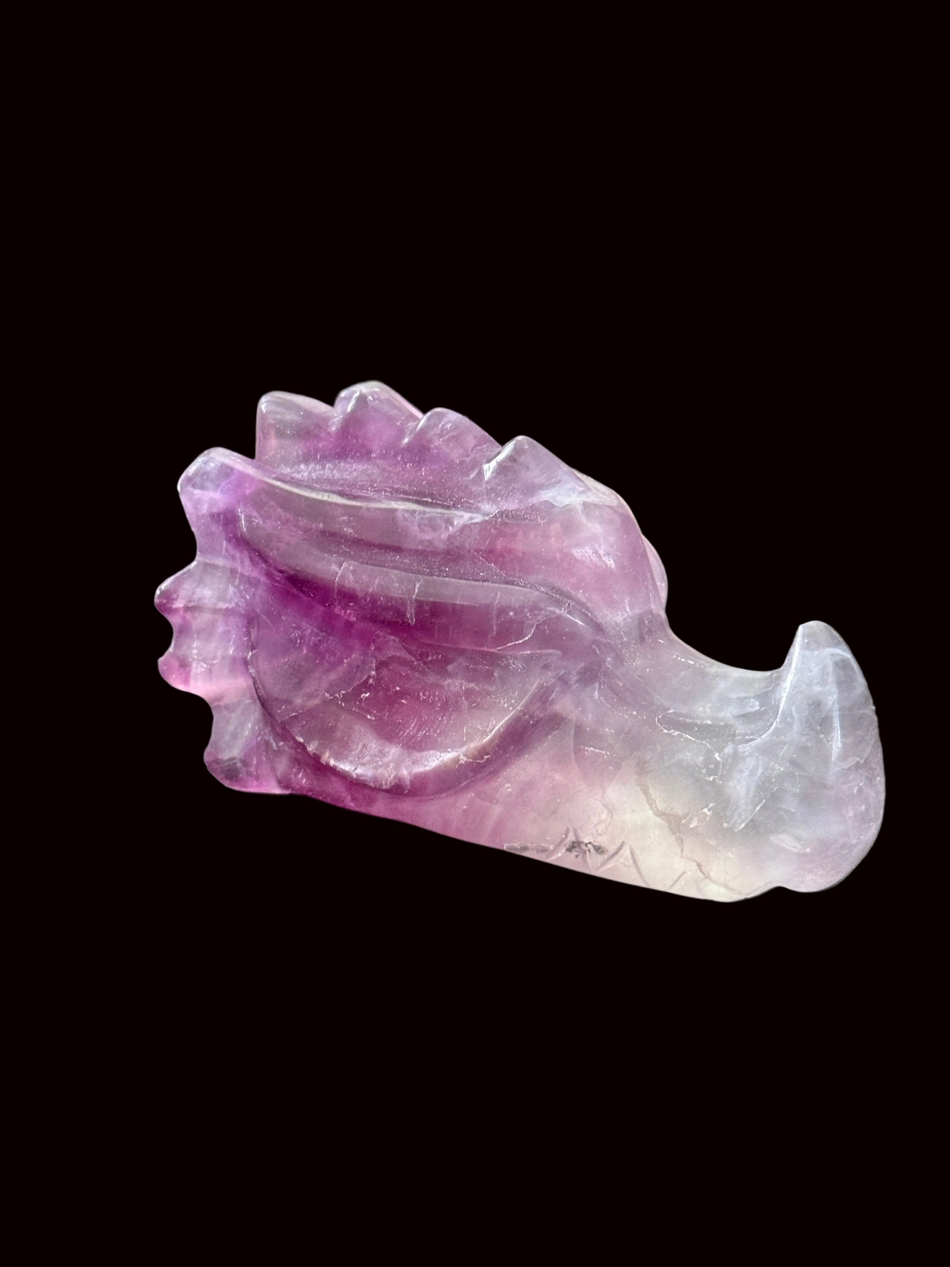 Lavender purple fluorite crystal dragon head carving top-down view showing full detail