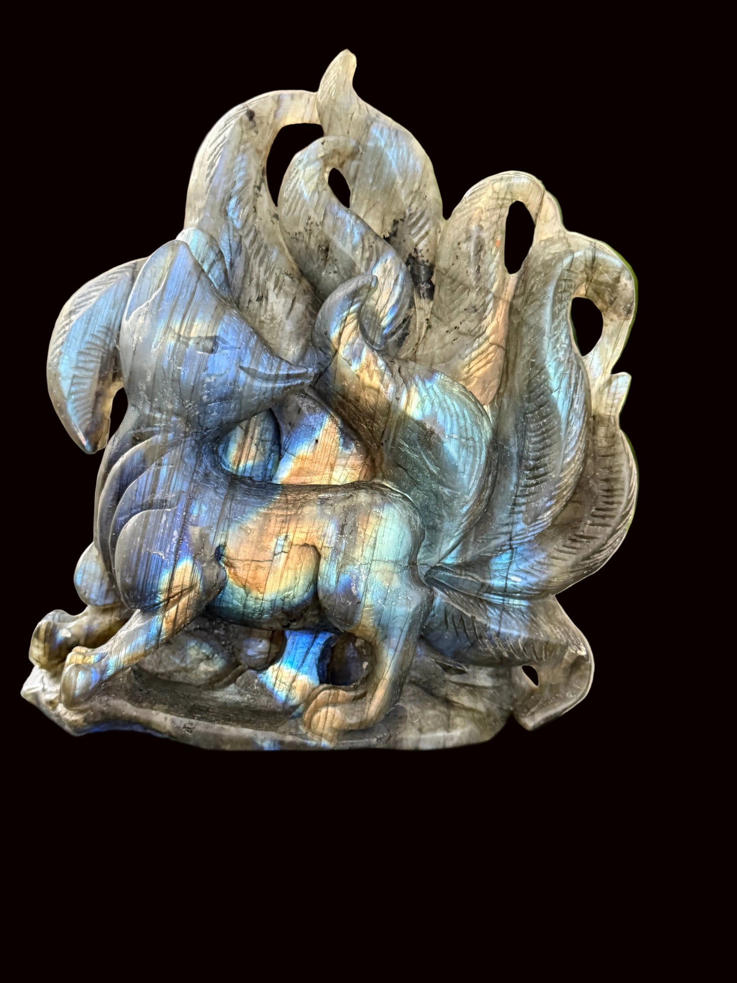 Labradorite nine-tail fox crystal carving side view showing iridescent flash