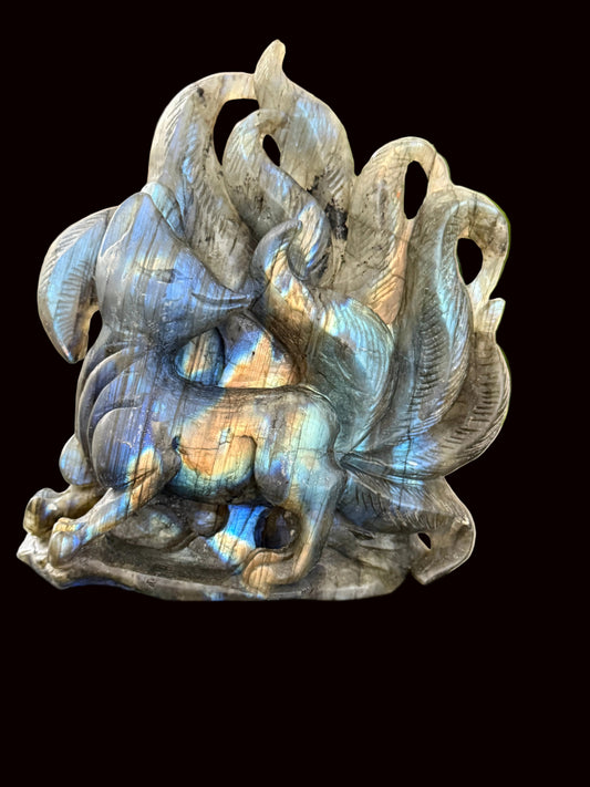Labradorite nine-tail fox crystal carving side view showing iridescent flash