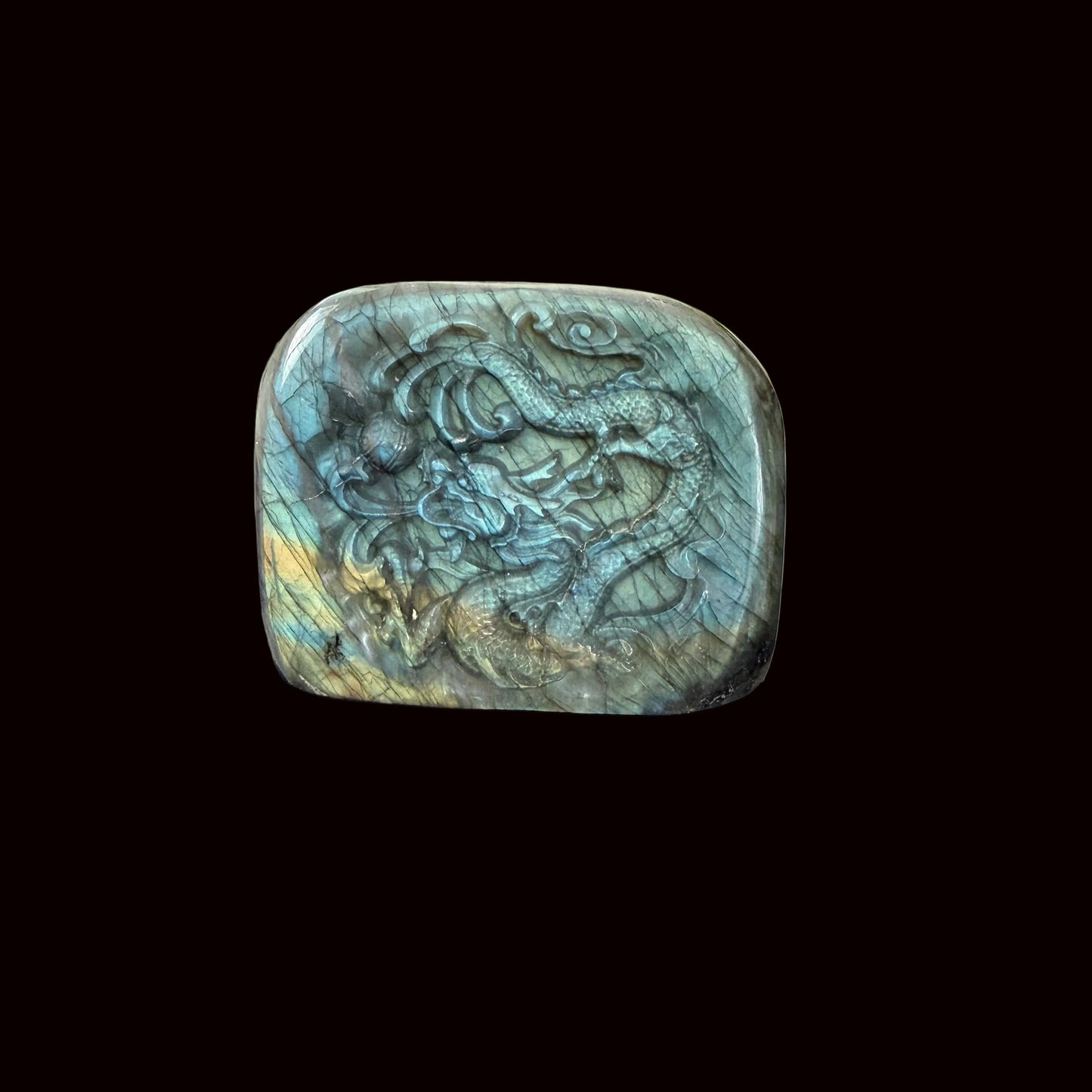 Labradorite freeform dragon carving standing on dark table showing full front face