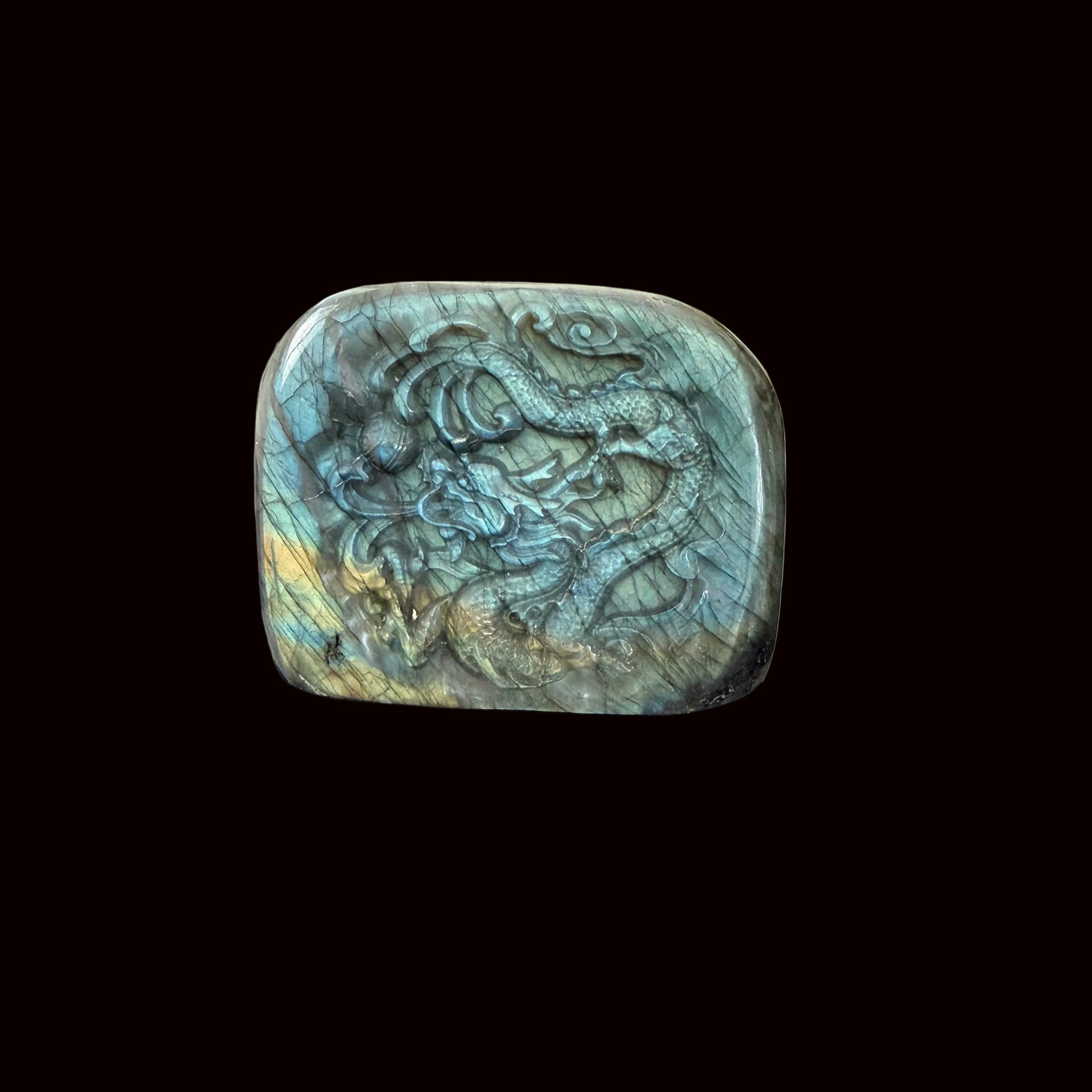 Labradorite freeform dragon carving standing on dark table showing full front face