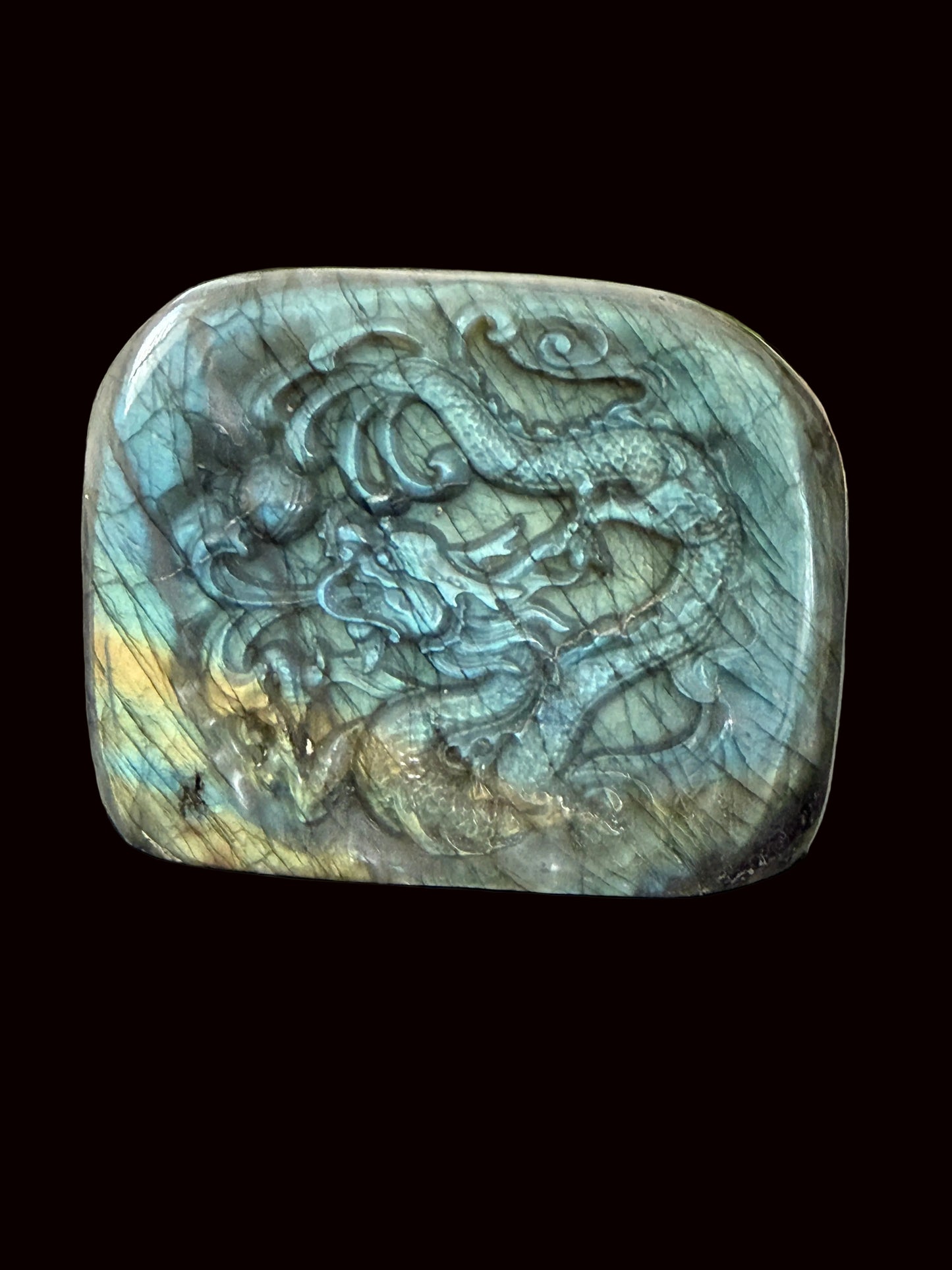 Labradorite freeform dragon carving side angle showing depth of carving and flash