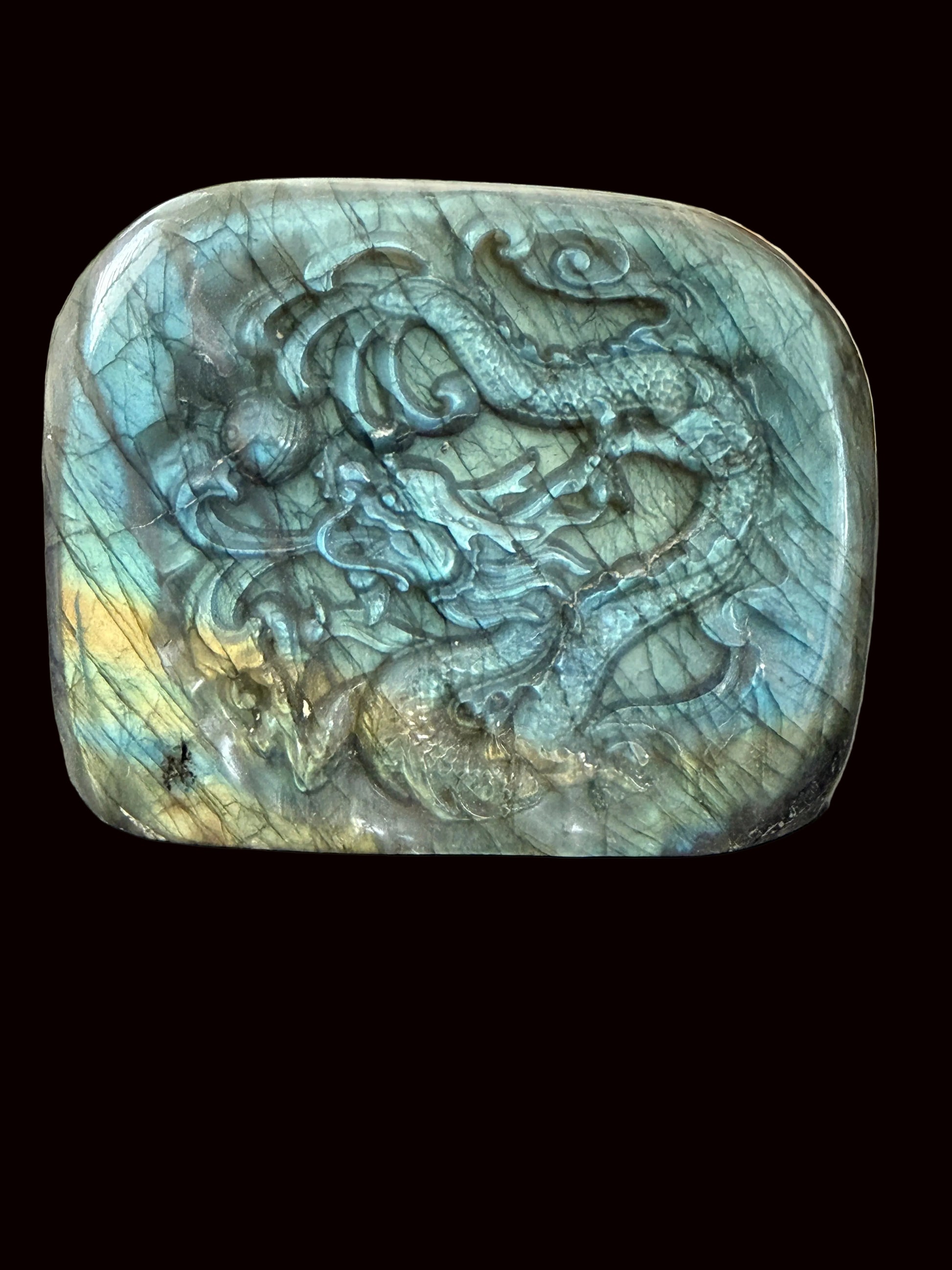 Labradorite freeform dragon carving close-up showing dragon scales and labradorescence