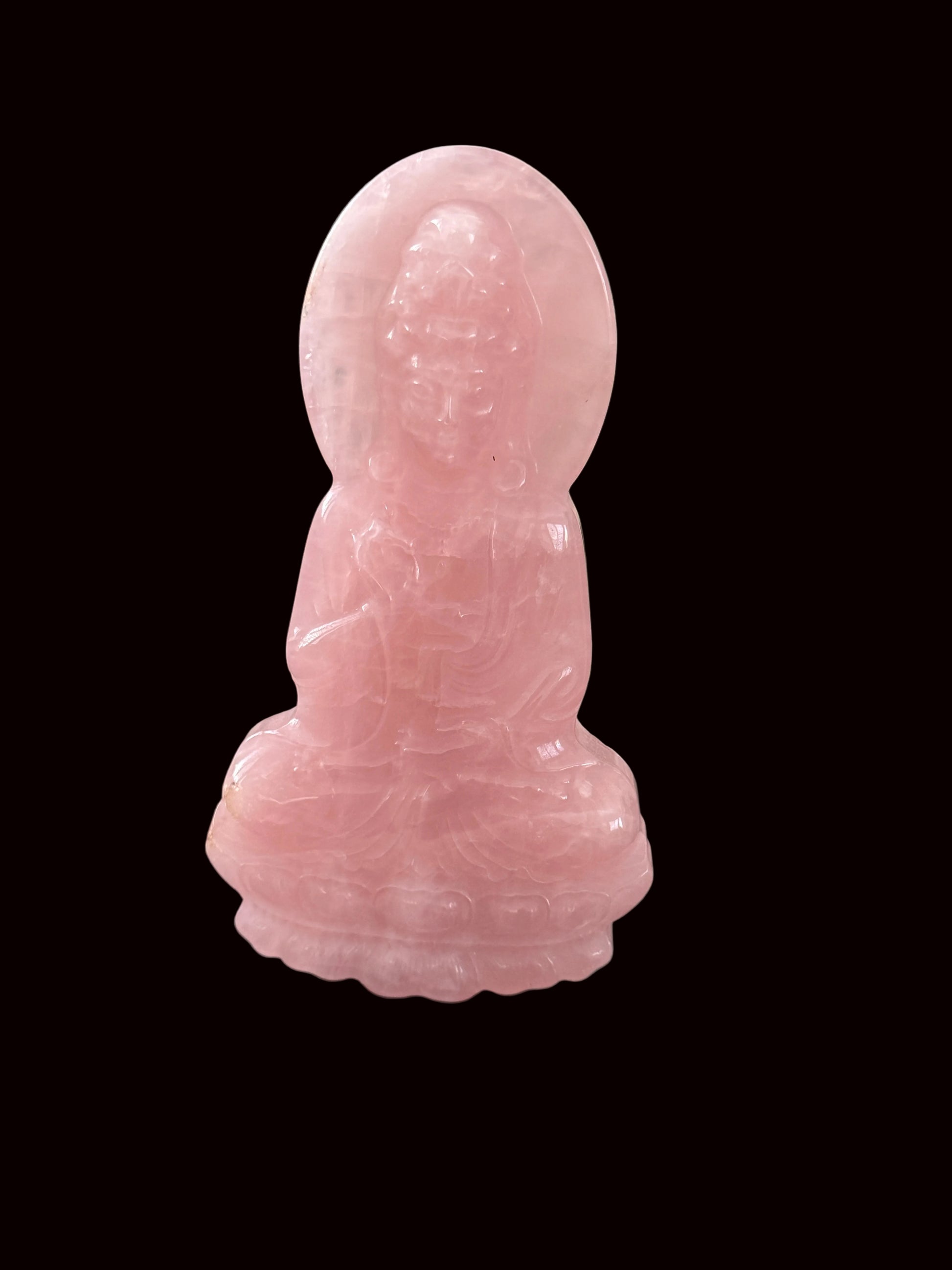 Rose quartz Guan Yin carving close-up showing translucent blush pink stone quality