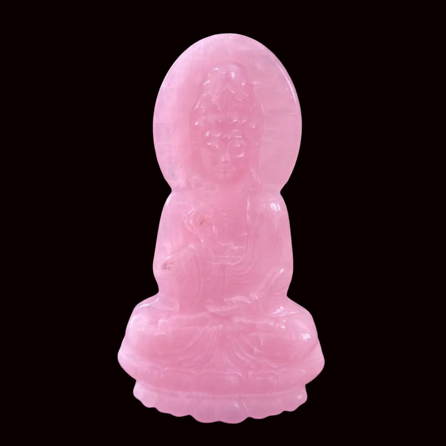 Rose quartz Guan Yin carving front view showing detailed face, crown, and robes
