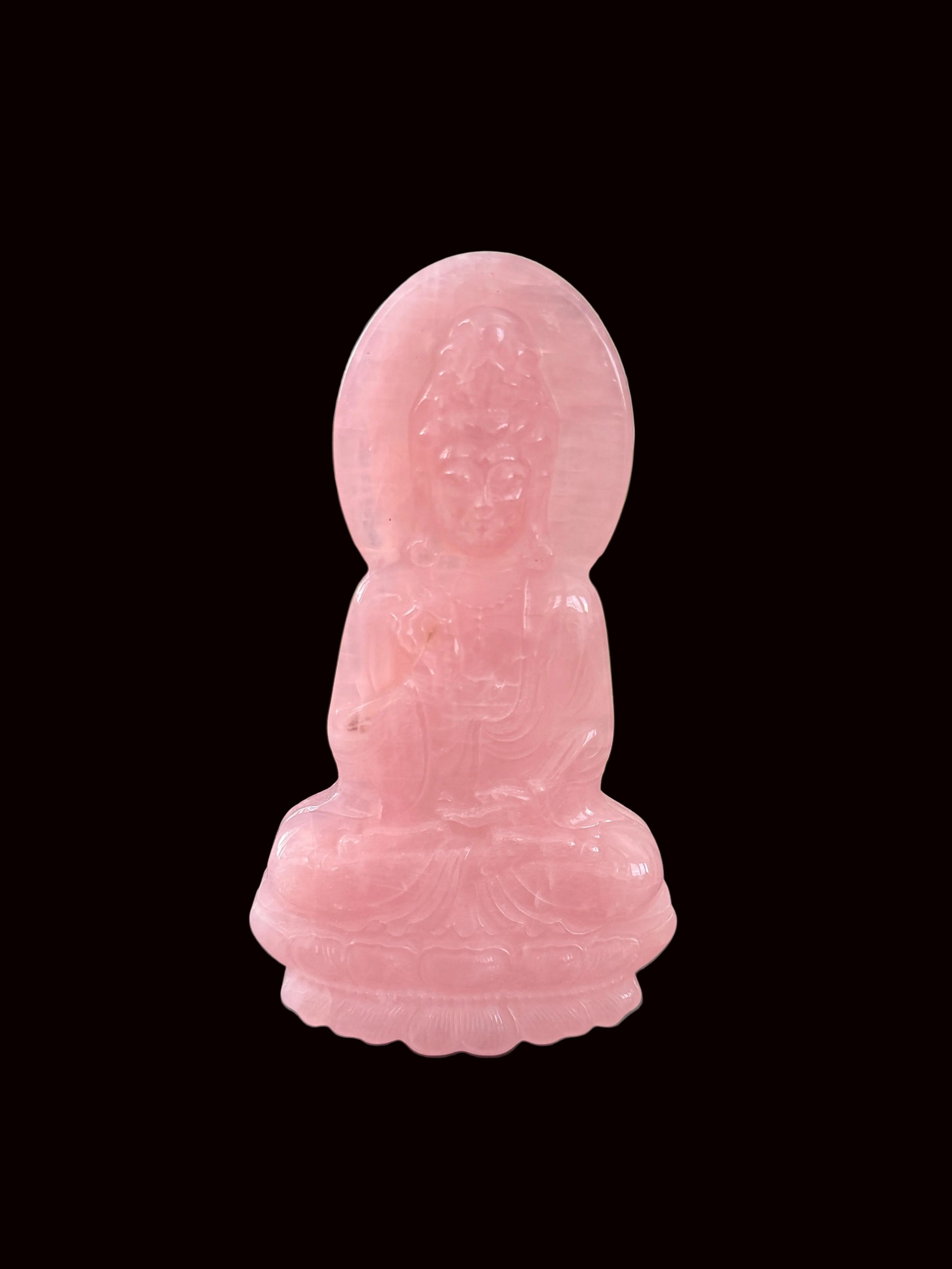 Rose quartz Guan Yin carving side angle view showing depth and translucency