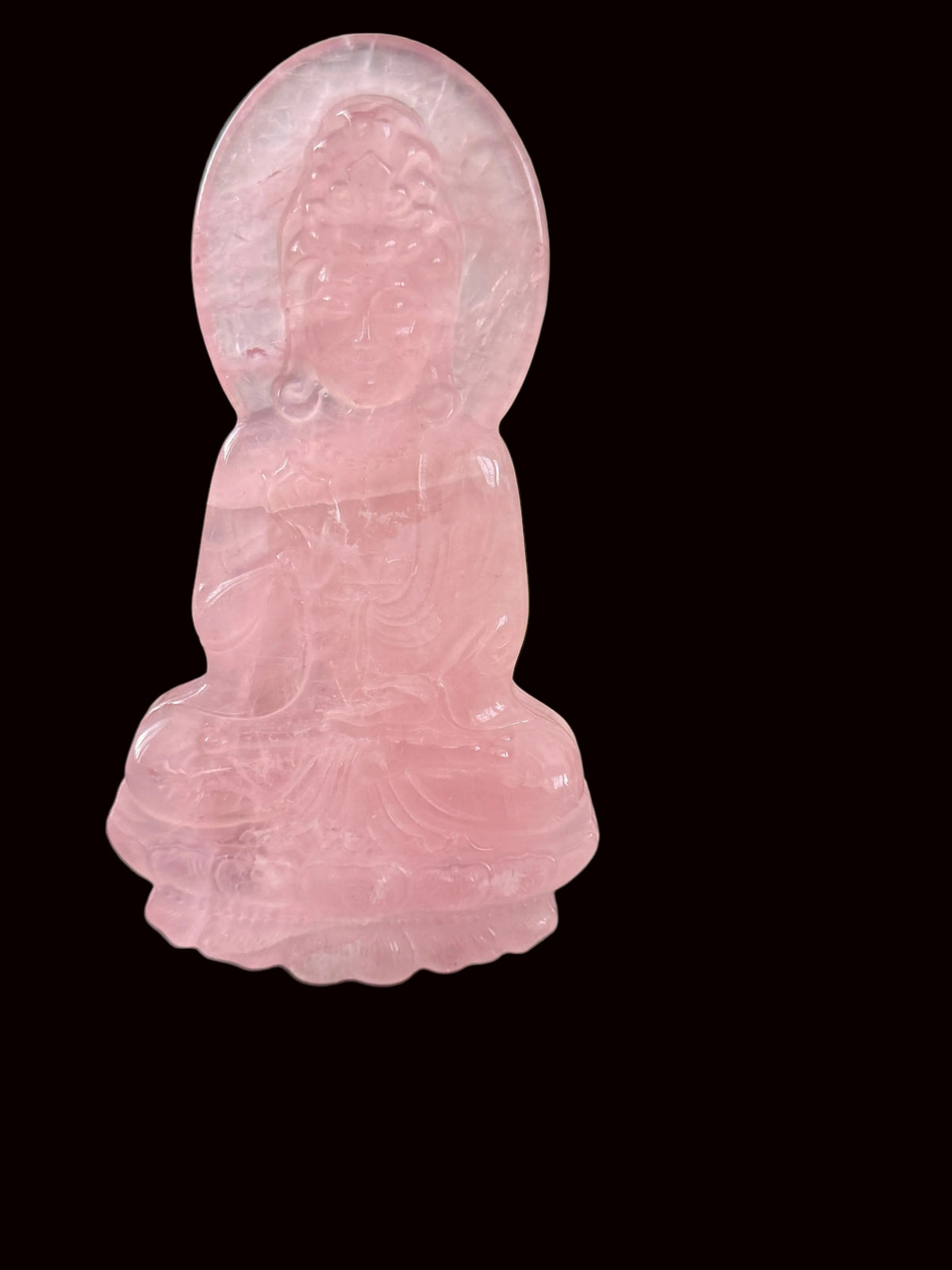 Rose quartz Guan Yin slab carving standing on black table in altar setting, front view