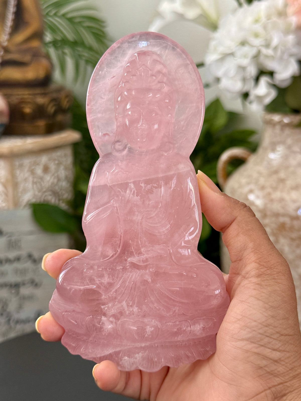 Rose quartz Guan Yin slab carving held in hand showing size and front detail