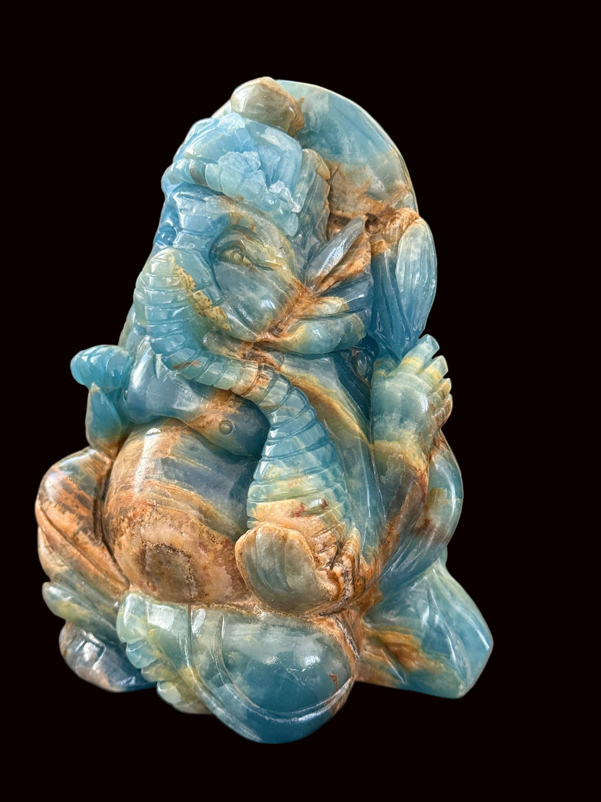 Blue onyx Ganesha carving back view showing full three-dimensional carving and stone patterning