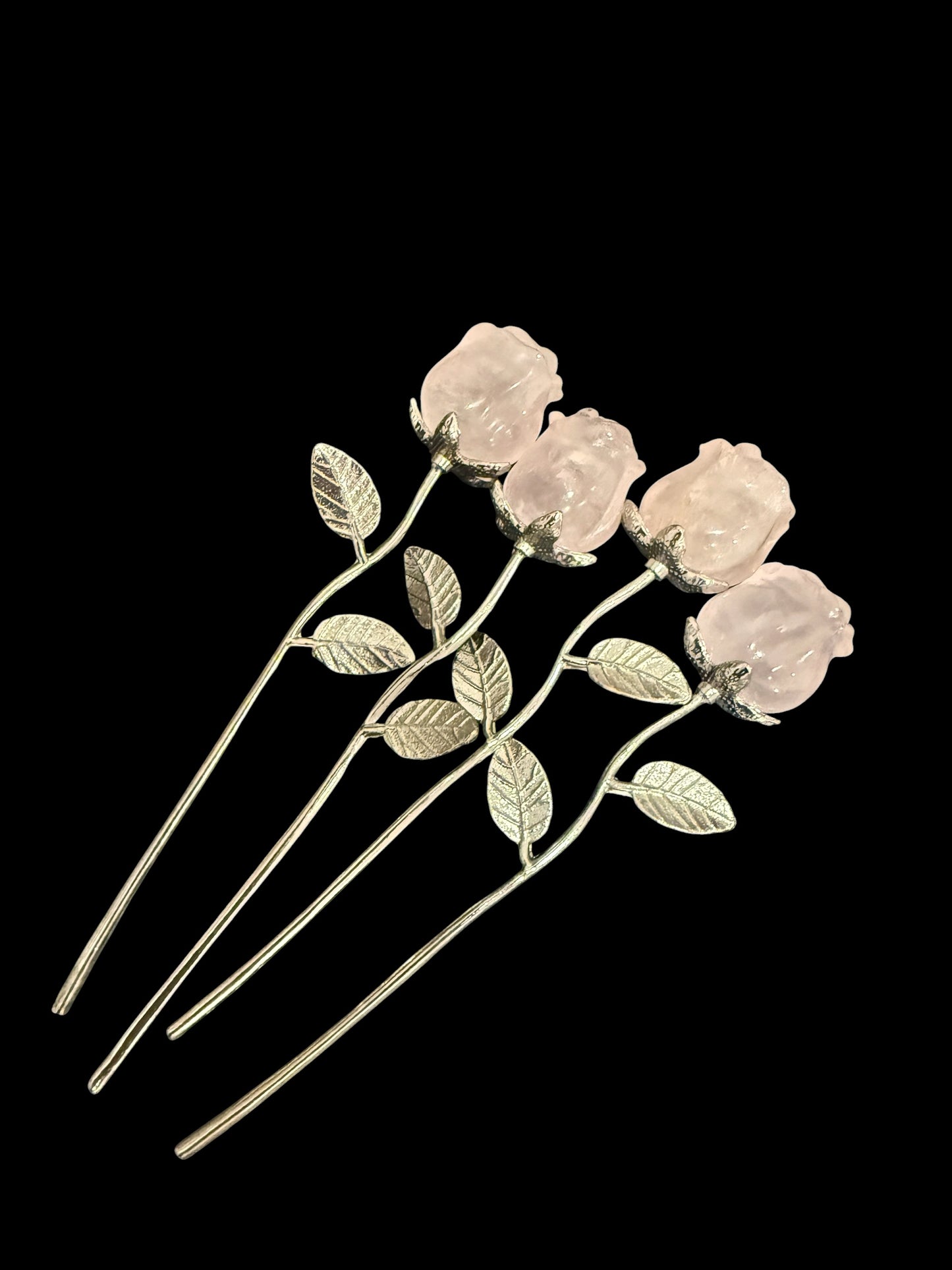 Three natural rose quartz crystal roses on silver stems - group display