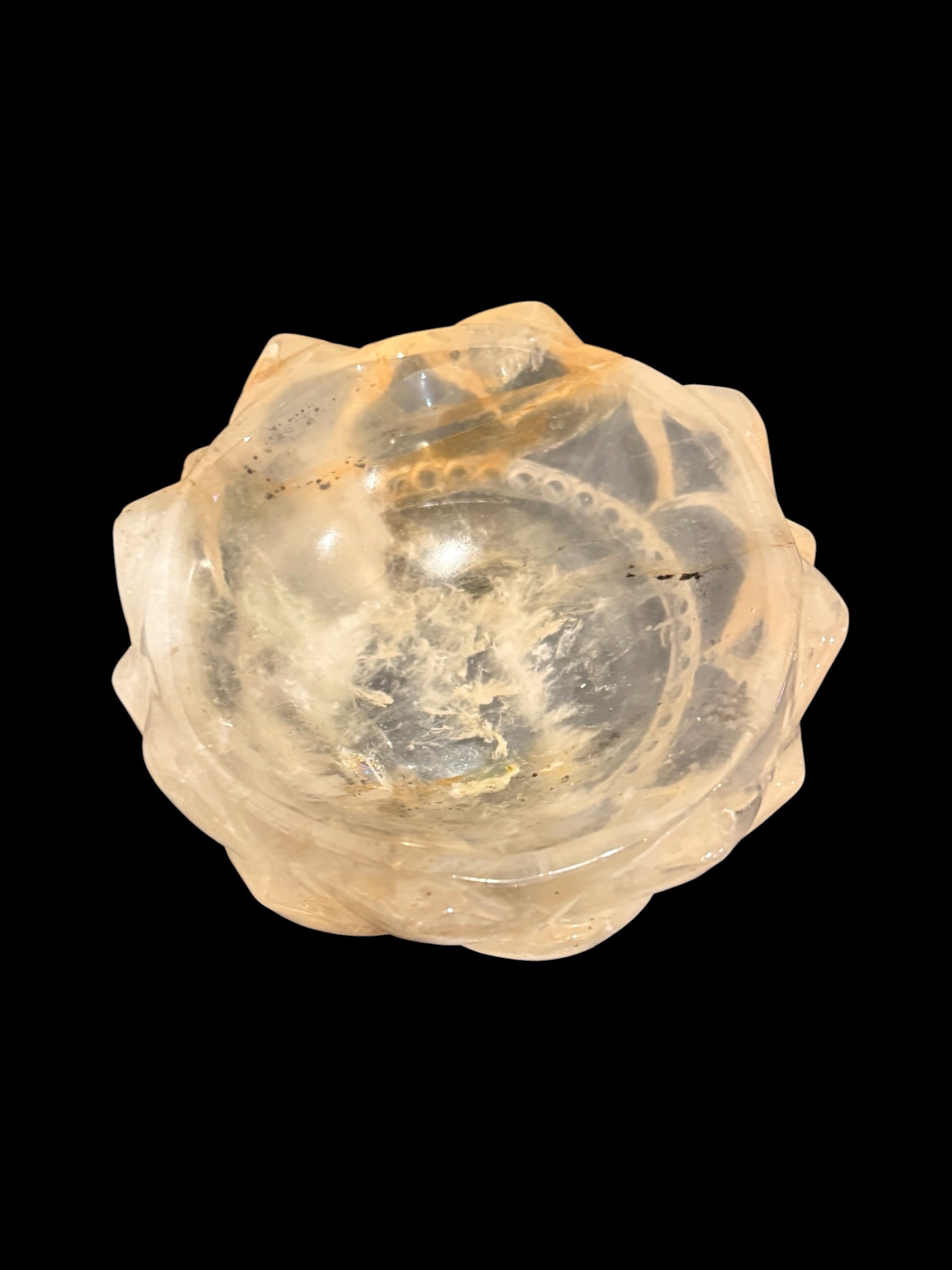 Golden healer crystal lotus bowl - top view on black background