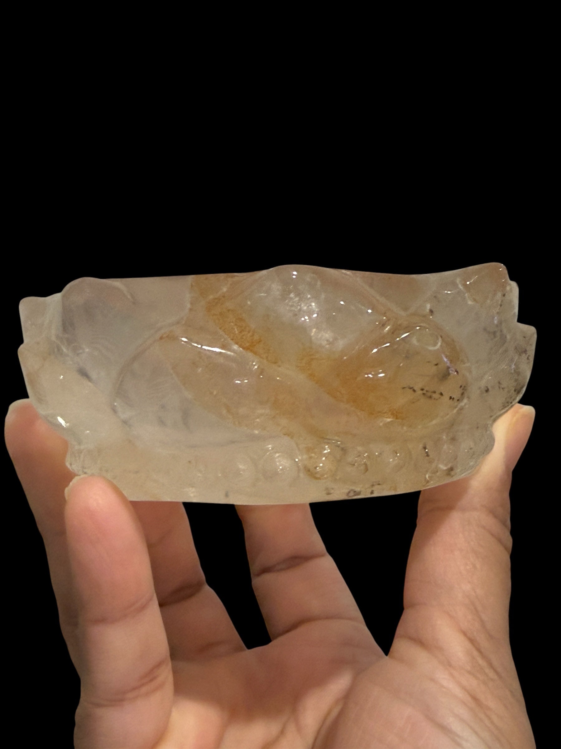 Golden healer crystal lotus bowl - side view held in hand showing depth