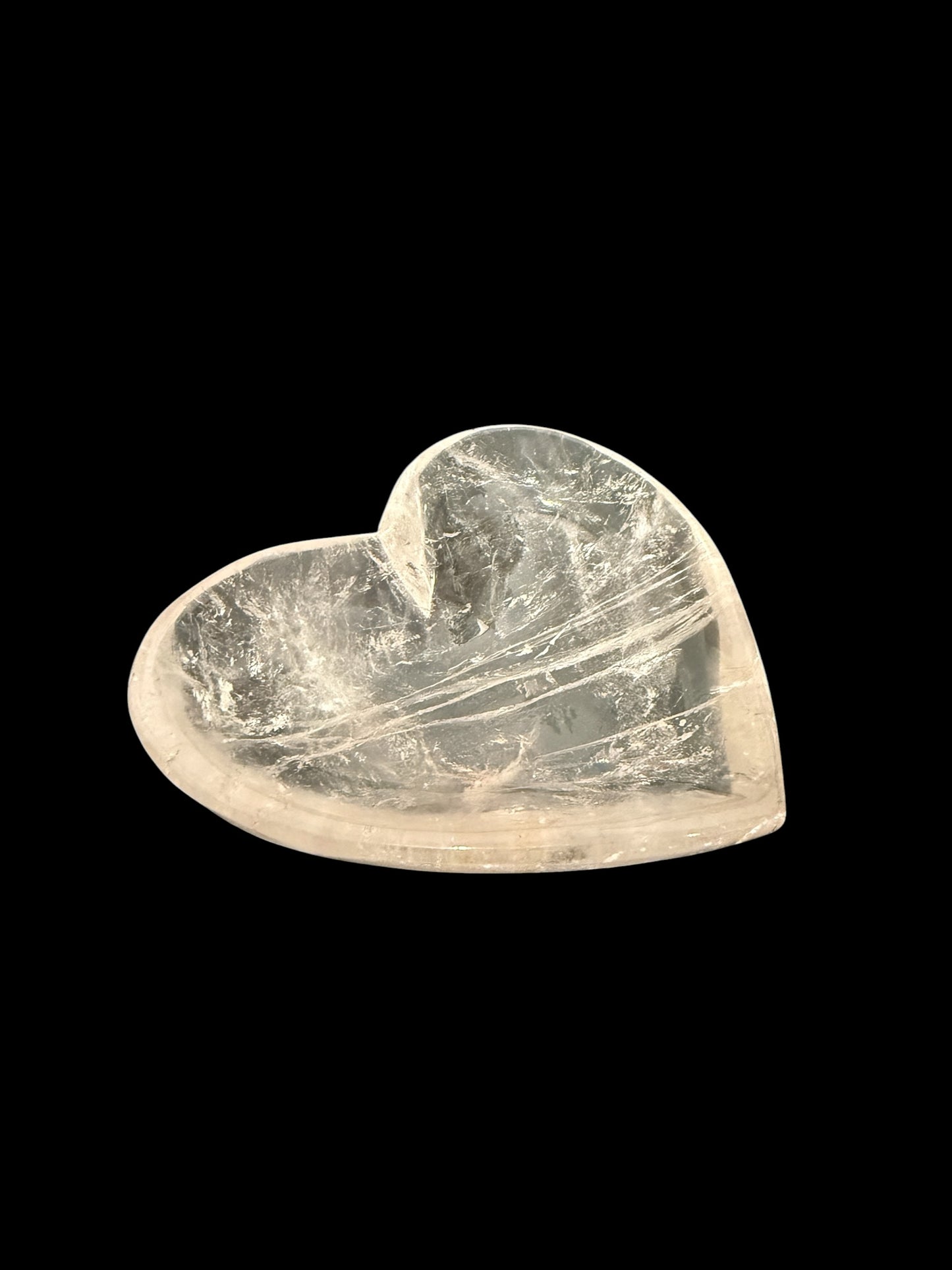 Natural clear quartz crystal heart bowl - top angled view on black background