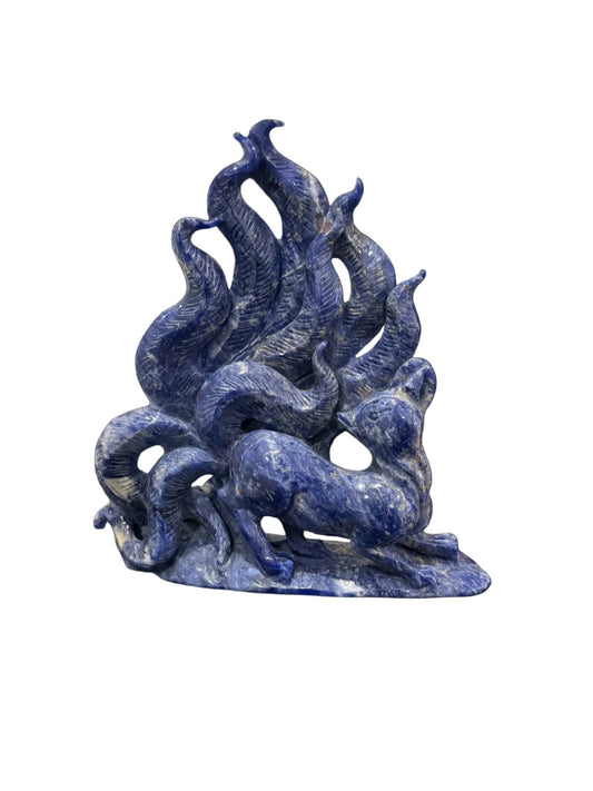 Sodalite nine-tail fox crystal carving front view showing flowing tails and fox figure in deep blue