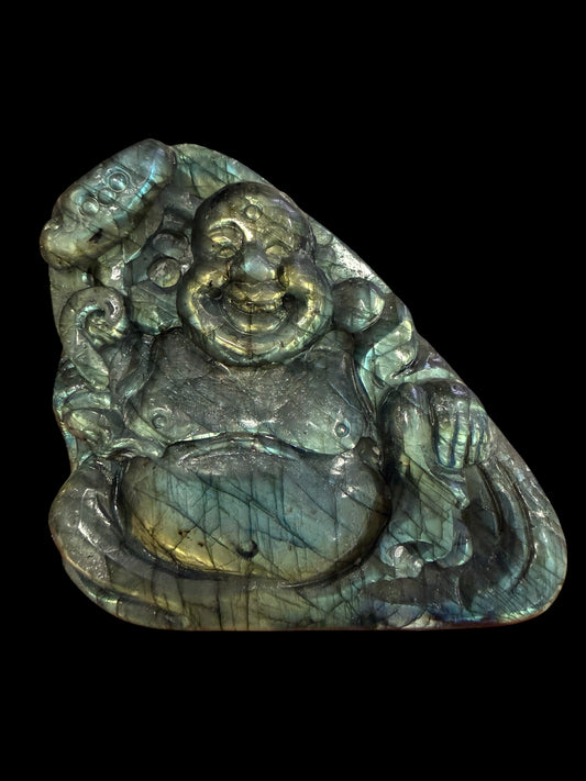 Labradorite laughing Buddha carving on black background showing full flash
