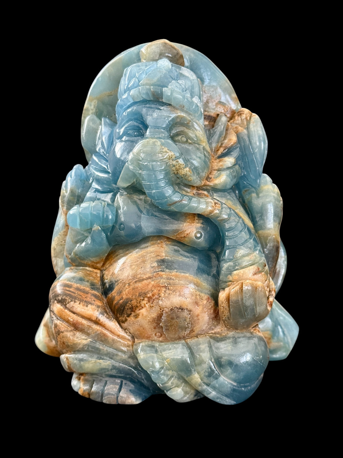 Blue onyx Ganesha crystal carving clean product shot on black background showing full front detail