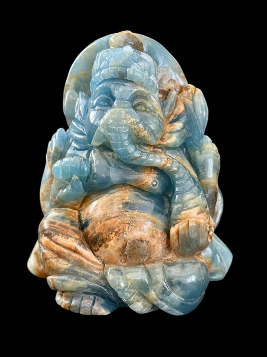 Blue onyx Ganesha crystal carving clean product shot on black background showing full front detail