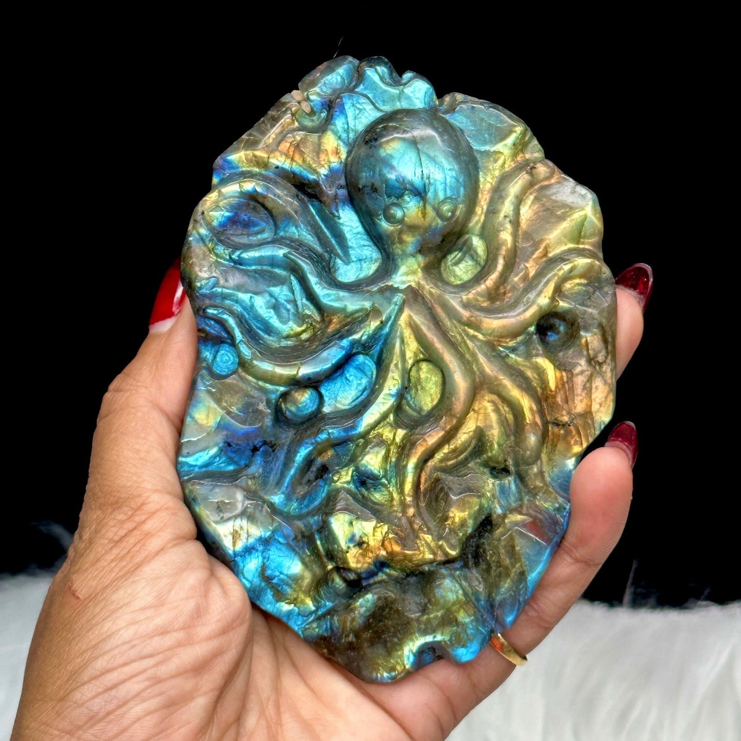 Flashy labradorite hand carved octopus carving with stand.