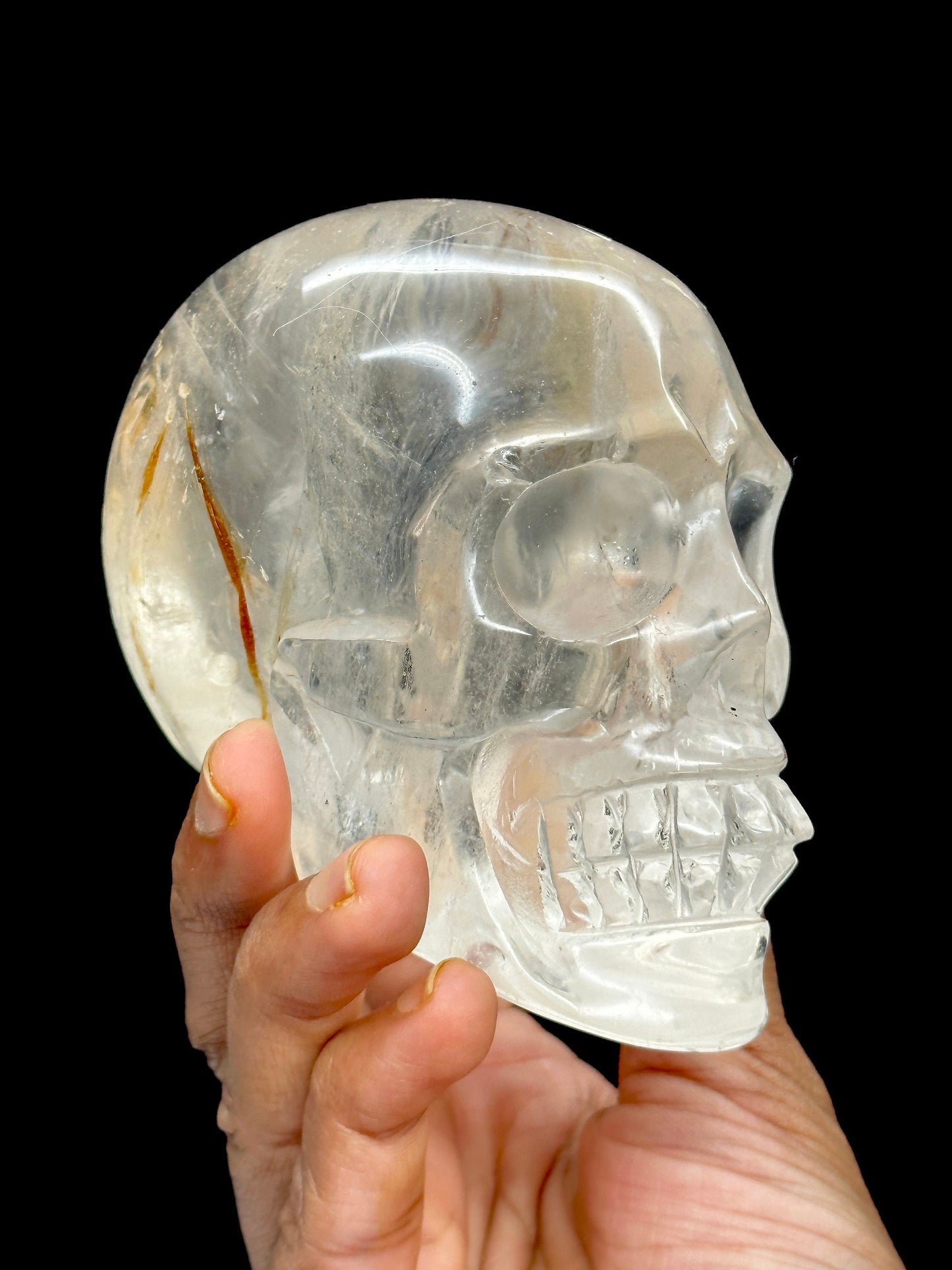 Clear Quartz Crystal Skull with Hematite Inclusion.