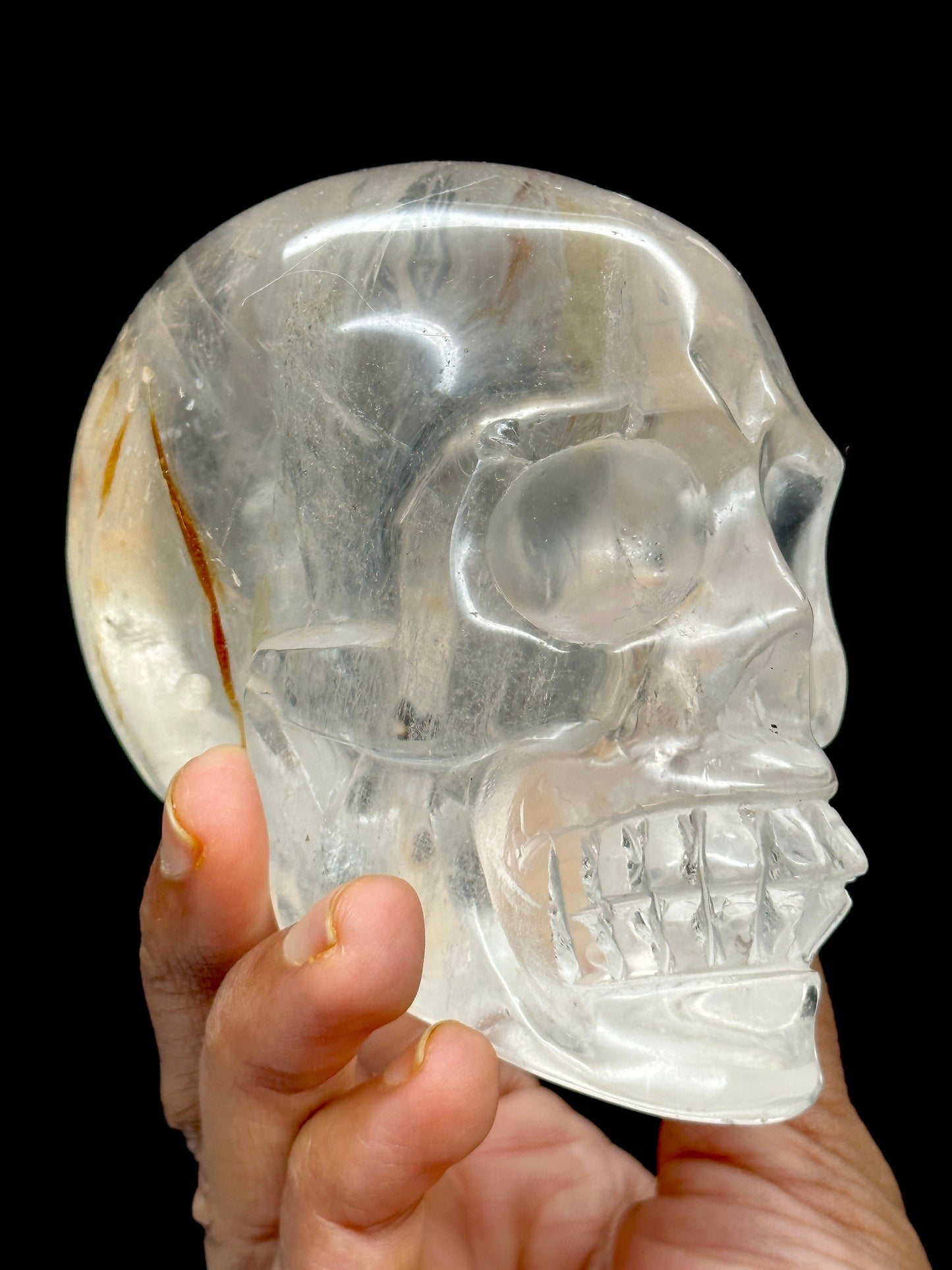 Clear Quartz Crystal Skull with Hematite Inclusion.