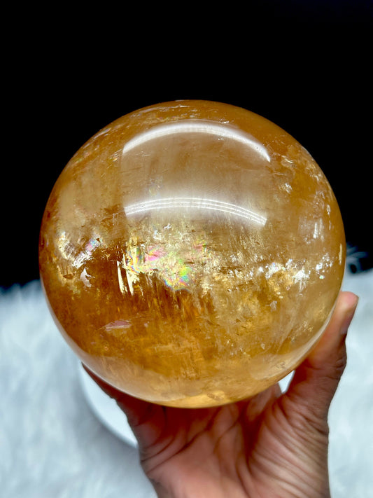 Rainbow filled large honey calcite sphere