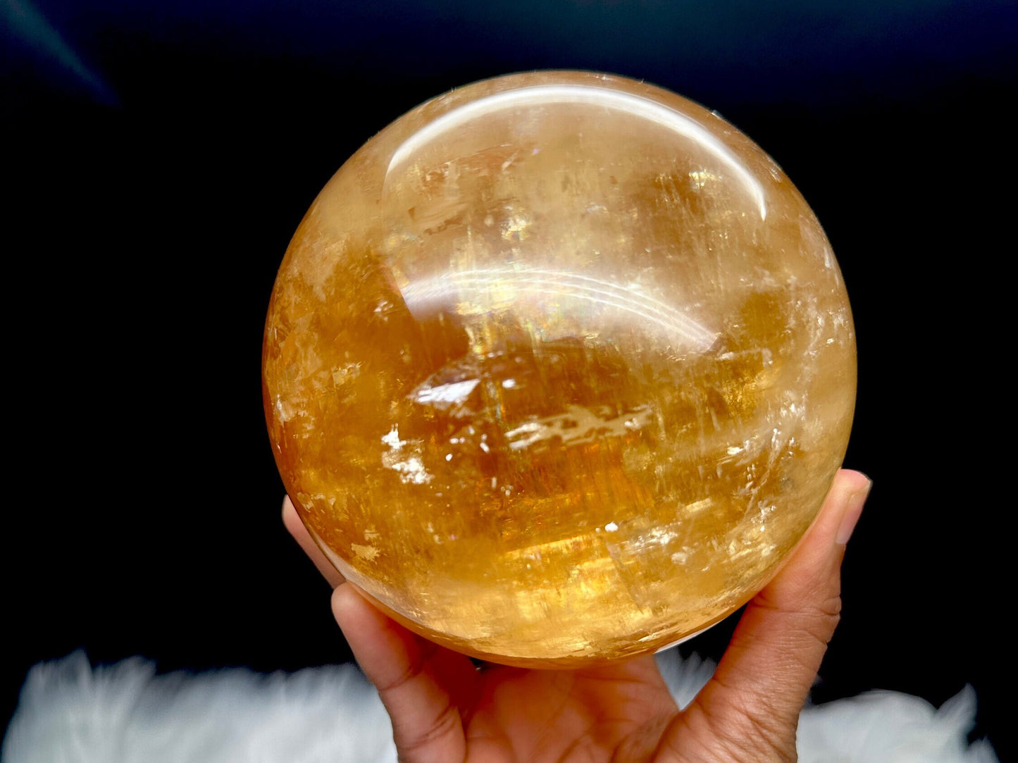 Rainbow filled large honey calcite sphere